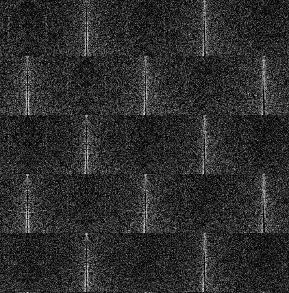 A digital pattern composed of grainy greyscale rectangles tiled in rows. The density of digital noise is concentrated at the centre of each rectangle and diffuses towards the edges, creating an illusory beveled effect. 

