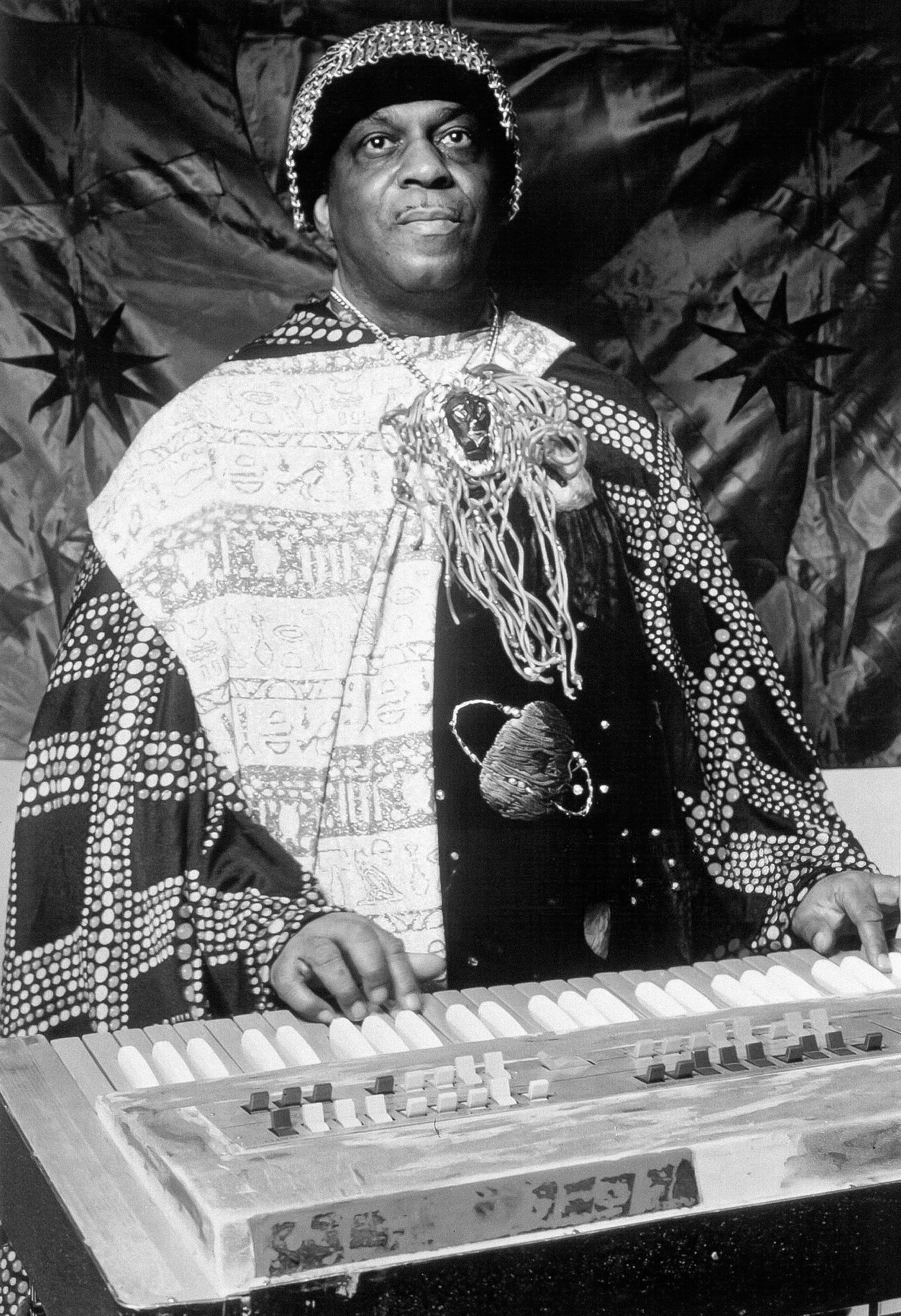 American jazz musician Sun Ra in a publicity photo promoting the 1973 reissue of his album *The Magic City* through Impulse! Records and ABC/Dunhill Records. The keyboard appears to be a Farfisa Professional 222 combo organ. 