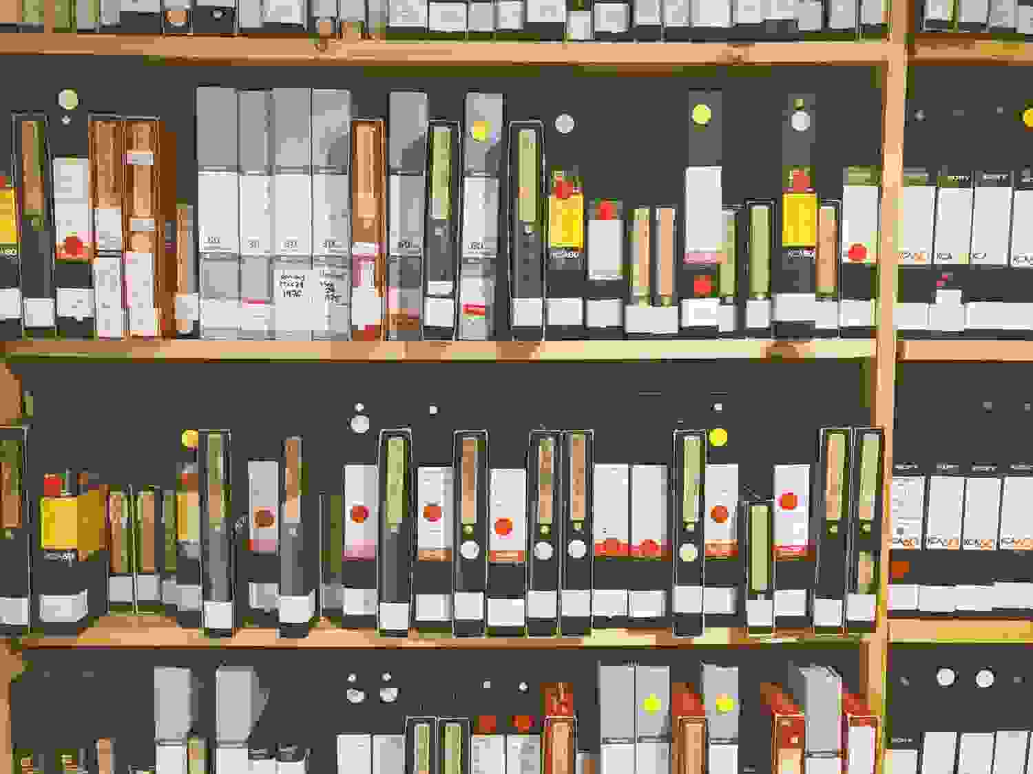A colour photo of labelled videotapes on shelves in Western Front’s archives.